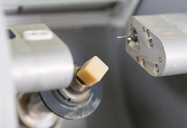 Dental handpiece with gold attachment in clinical operatory setting at dental office.
